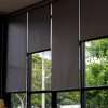 Black blinds over vertical glass windows in a luxury home
