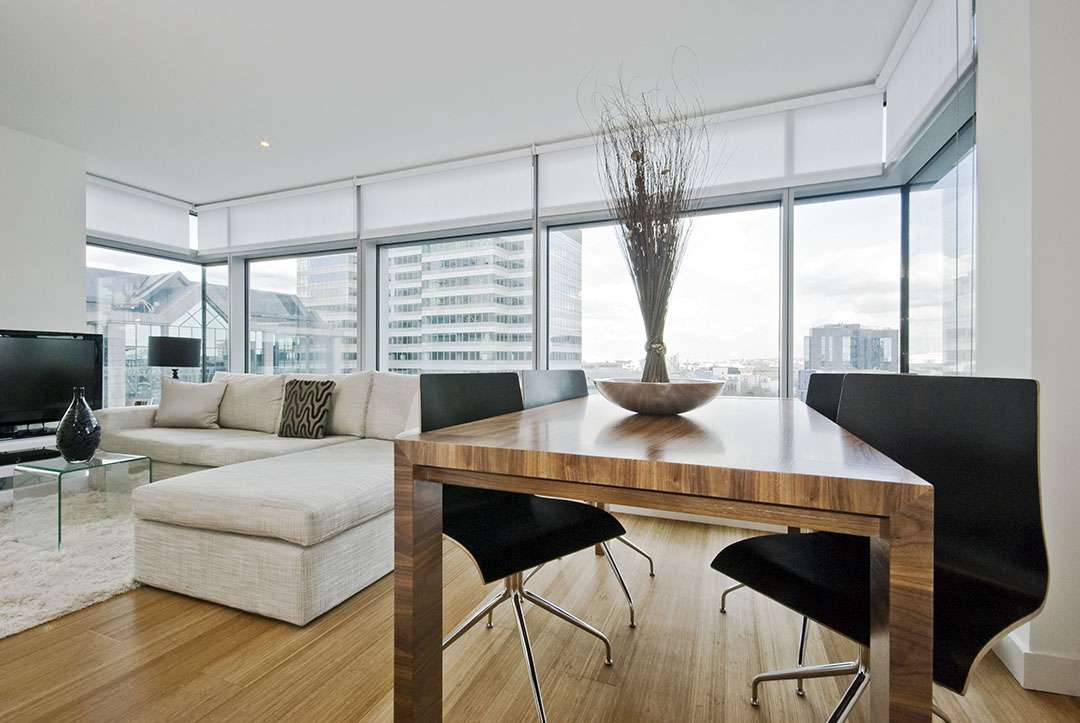 a-luxurious-living-room-space-with-attractive-modern-window-shades - Shade.Shop A luxurious living room space with attractive, modern window shades
