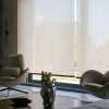 Interior design with modern chairs and motorized roller blinds